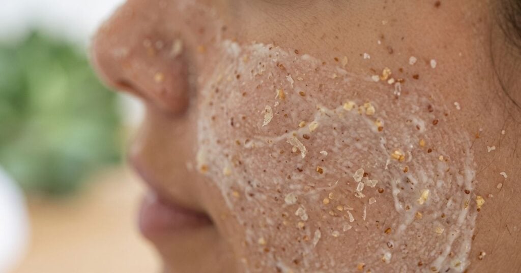 Fine-textured physical scrub applied with gentle pressure to avoid micro-tears