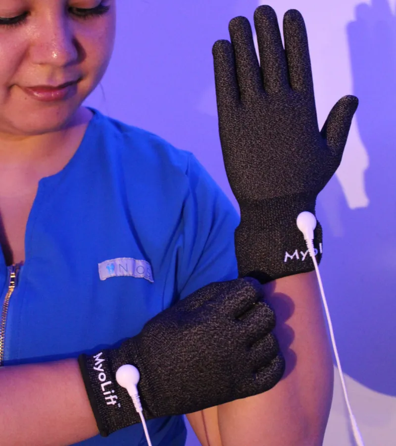 Nios Skin Lab esthetician wearing conductive microcurrent gloves